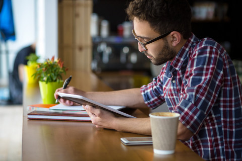 man studying and journaling